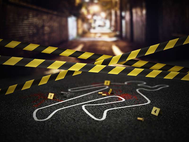 A staged crime scene outline with evidence markers and yellow caution tape in an alleyway.