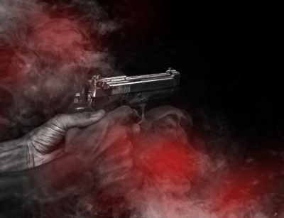 A hand holding a pistol with smoke around it, set against a dark background.