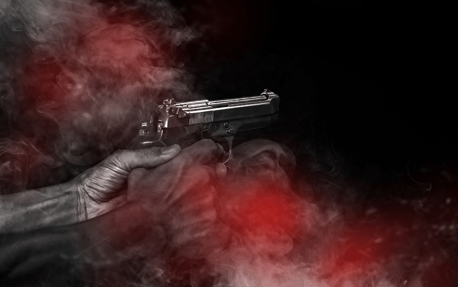 A hand holding a pistol with smoke around it, against a dark background.
