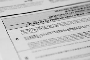 The image shows a close-up of a bilingual (English and Chinese) official document with a title CITY AND COUNTY PROPOSITIONS and a question for a public vote.