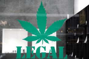 The image displays a large green cannabis leaf graphic with the word LEGAL beneath it, suggesting a place where cannabis is legally sold or used.