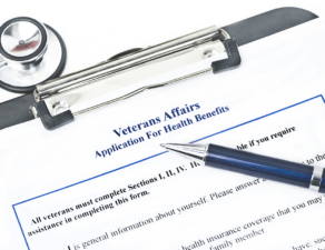 An application form titled Veterans Affairs Application for Health Benefits with a pen and a stethoscope on top.